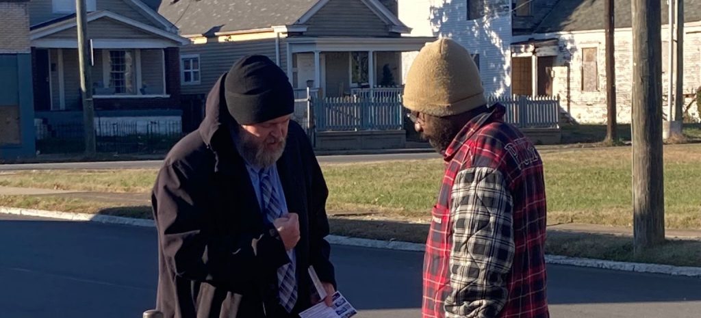 pastor joshua tapp preaching the gospel and praying with a saved man in west louisville kentucky